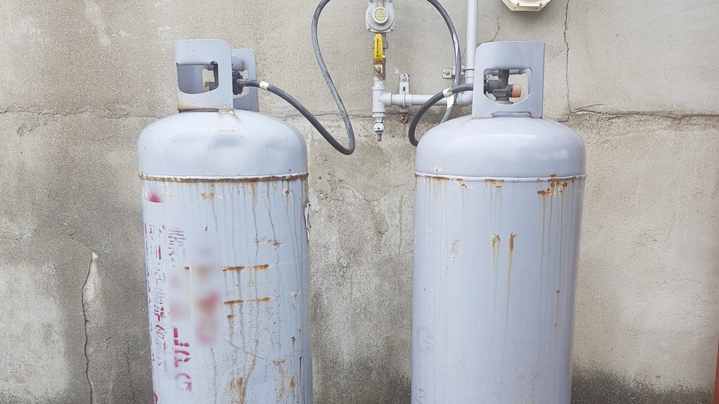 Two LPG cylinders connected to a household gas supply, as Pakistan's LPG price surge pushes market rates far above the official price