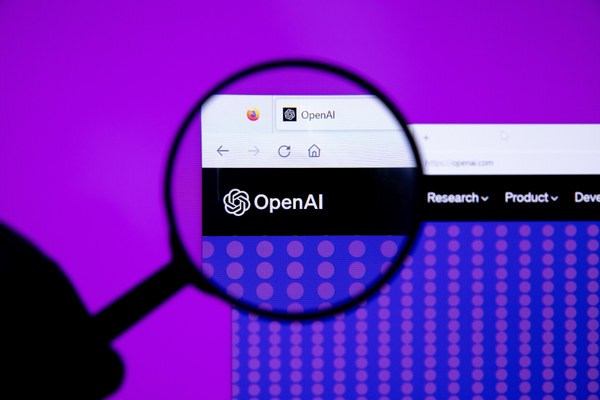 The OpenAI logo under a magnifying glass, as eight US states sue the company over ChatGPT safety