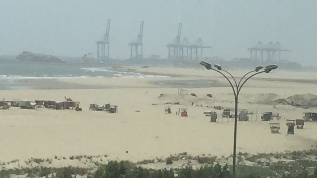 Gwadar beach with the port cranes in the background, Balochistan.