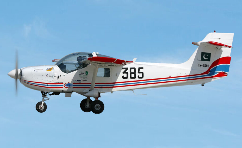 A Pakistan MFI-17 Super Mushshak training aircraft in flight with Pakistan flag markings on its tail