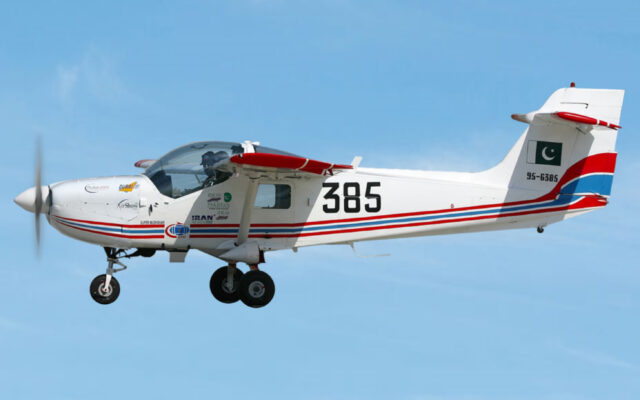 A Pakistan MFI-17 Super Mushshak training aircraft in flight with Pakistan flag markings on its tail
