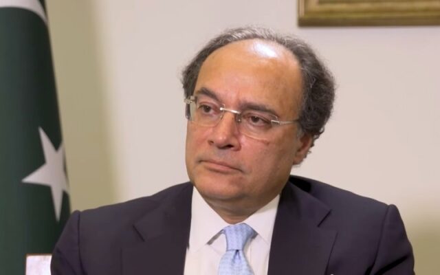 Pakistan Finance Minister Muhammad Aurangzeb, who set a B+ credit rating target in a Bloomberg interview in Bangkok, seated beside the Pakistan flag