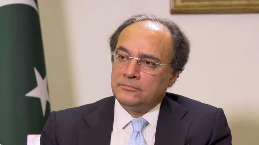 Pakistan Finance Minister Muhammad Aurangzeb, who set a B+ credit rating target in a Bloomberg interview in Bangkok, seated beside the Pakistan flag