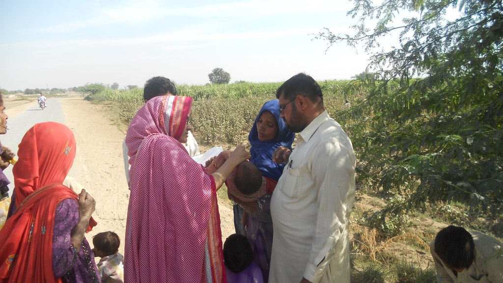 A health worker vaccinating a young child against polio during a field visit in Pakistan, as Peshawar and Khyber prepare a booster drive using needle-free jet injectors