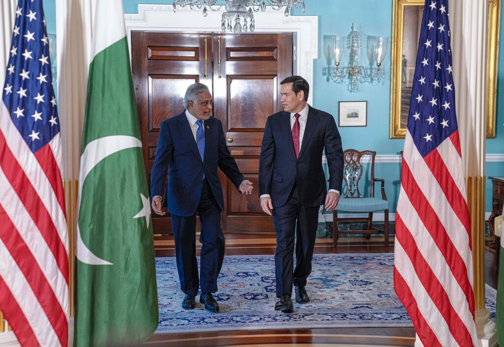 Pakistan Deputy Prime Minister and Foreign Minister Ishaq Dar, who warned the Afghan Taliban of consequences over inaction against terrorist groups, walking with US Secretary of State Marco Rubio beside the Pakistan flag at the US State Department