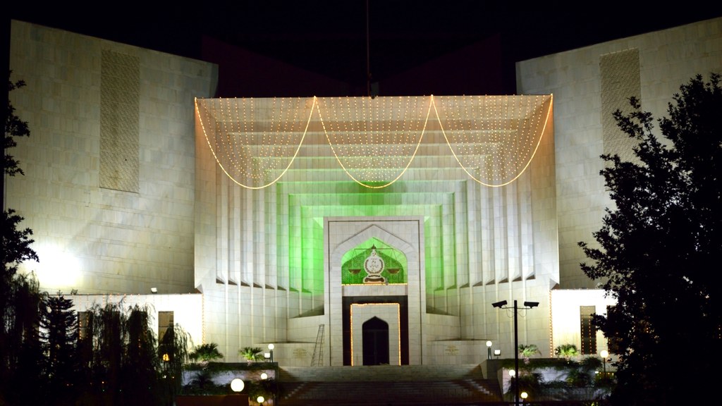 The Supreme Court of Pakistan building illuminated at night in Islamabad