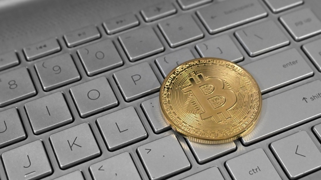 A physical Bitcoin coin on a laptop keyboard, shown in a file photograph.