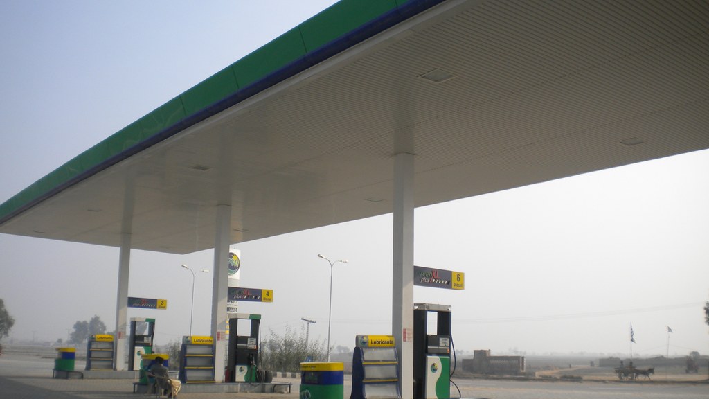 A PSO petrol station canopy with fuel pumps on a highway in Pakistan