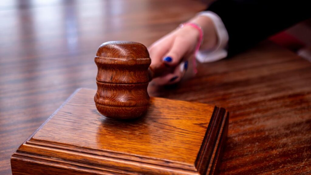 A wooden judge's gavel on a desk in a courtroom, symbolising the constitutional and legal battle ahead
