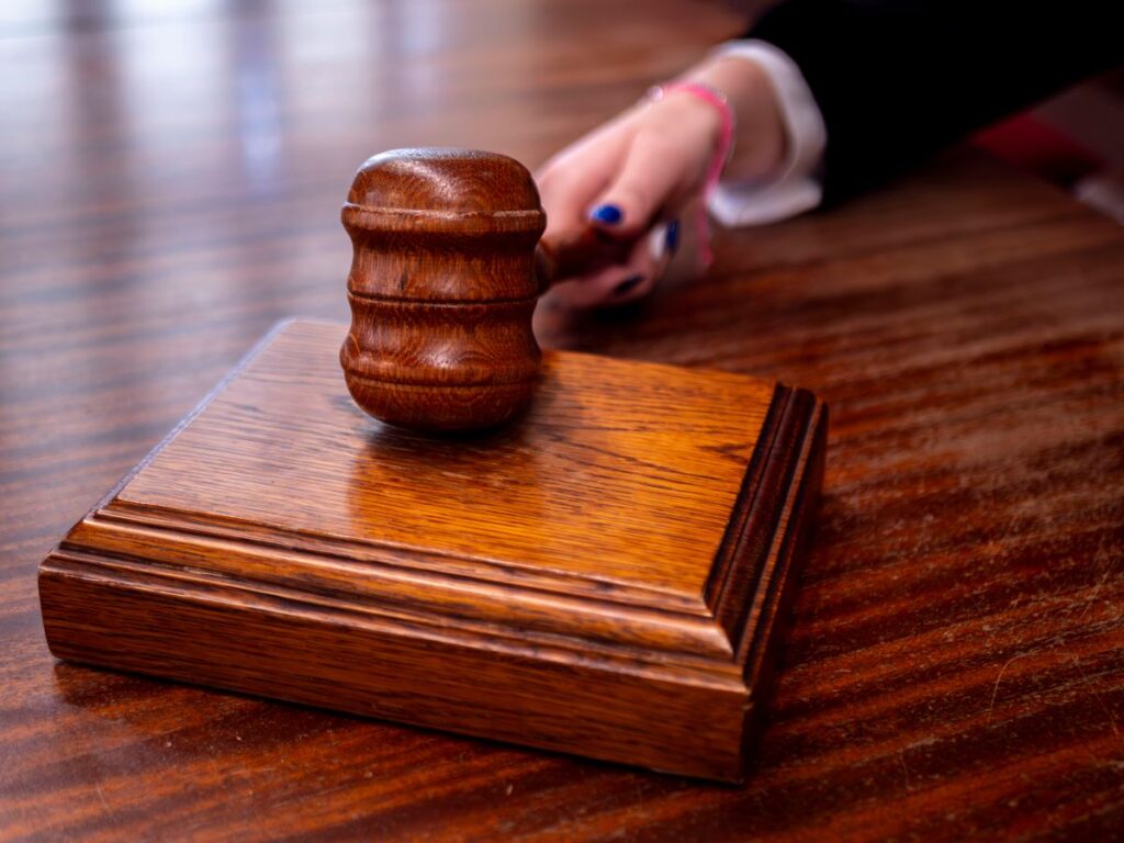A wooden judge's gavel on a desk in a courtroom, symbolising the constitutional and legal battle ahead