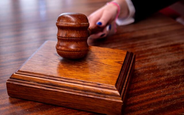 A wooden judge's gavel on a desk in a courtroom, symbolising the constitutional and legal battle ahead