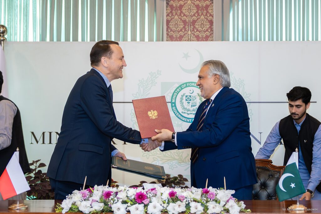 Pakistan's Foreign Minister Ishaq Dar exchanging documents at an official meeting
