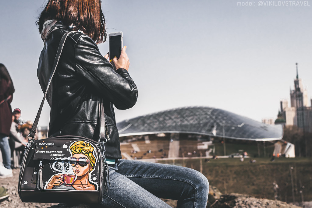 A woman using her smartphone to browse social media posts