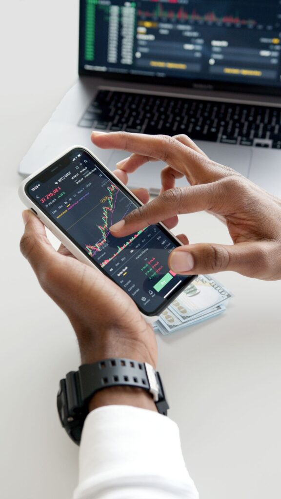 A smartphone trading app showing stock market charts and financial data