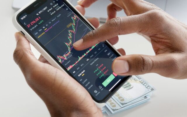 A smartphone trading app showing stock market charts and financial data